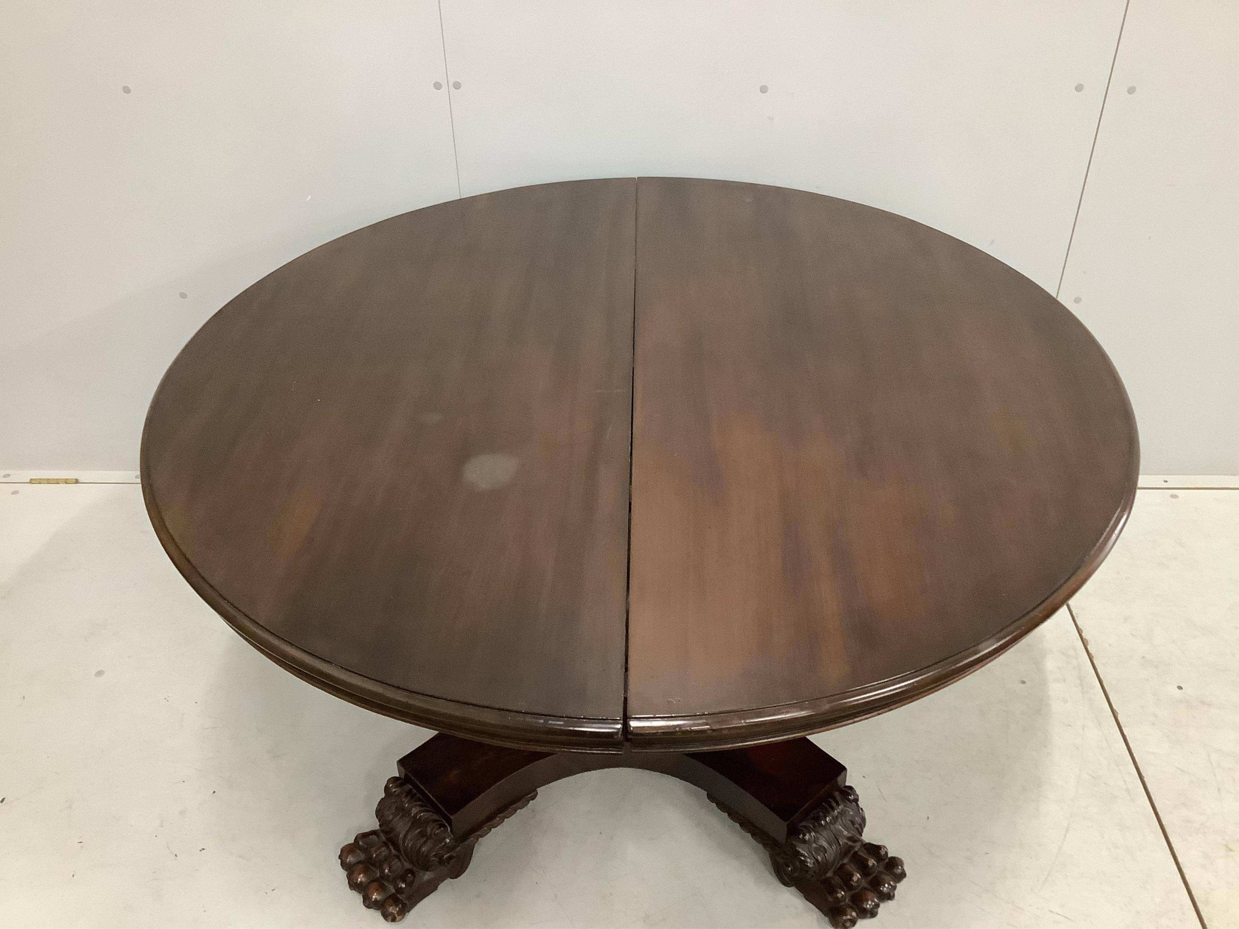 A George IV style circular mahogany extending dining table, 224cm extended, two spare leaves, width 134cm, height 74cm. Condition - fair to good